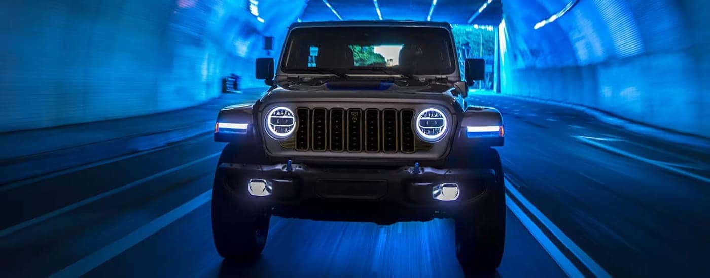 A grey 2024 Jeep Wrangler for sale near Mooresville driving through a tunnel.