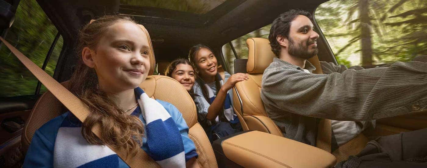 Family test driving a 2025 Jeep Grand Cherokee for sale near Statesville.