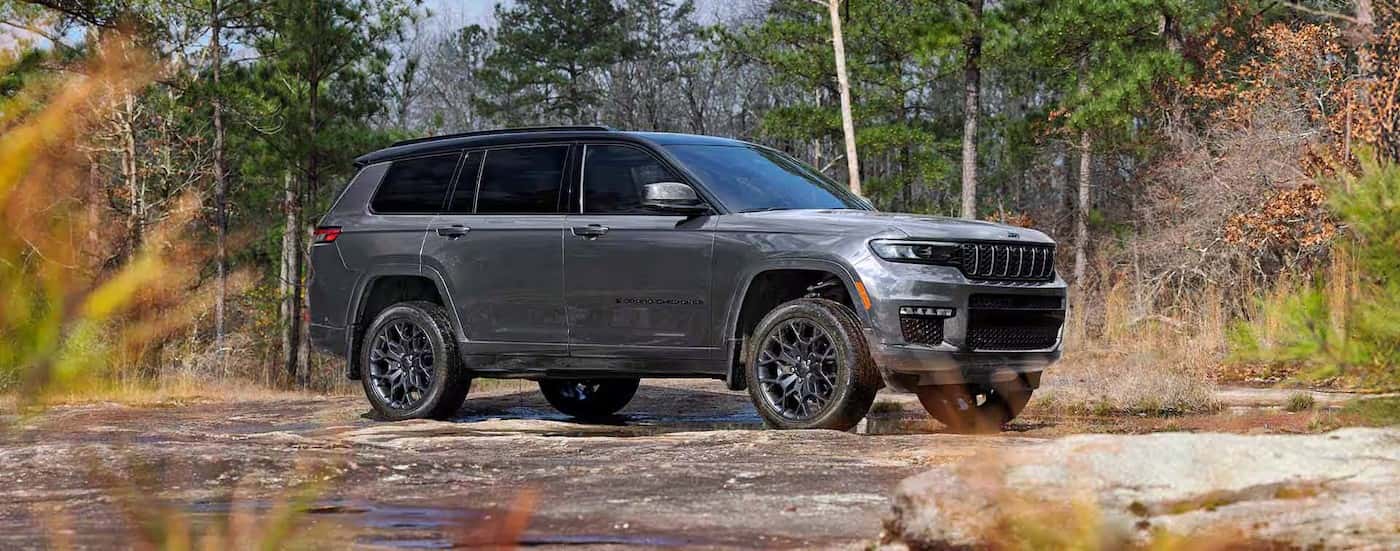 A gray 2025 Jeep Grand Cherokee L for sale near Mooresville is parked off-road.