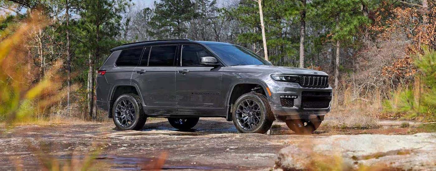 A gray 2025 Jeep Grand Cherokee L for Sale Near Charlotte parked off-road.
