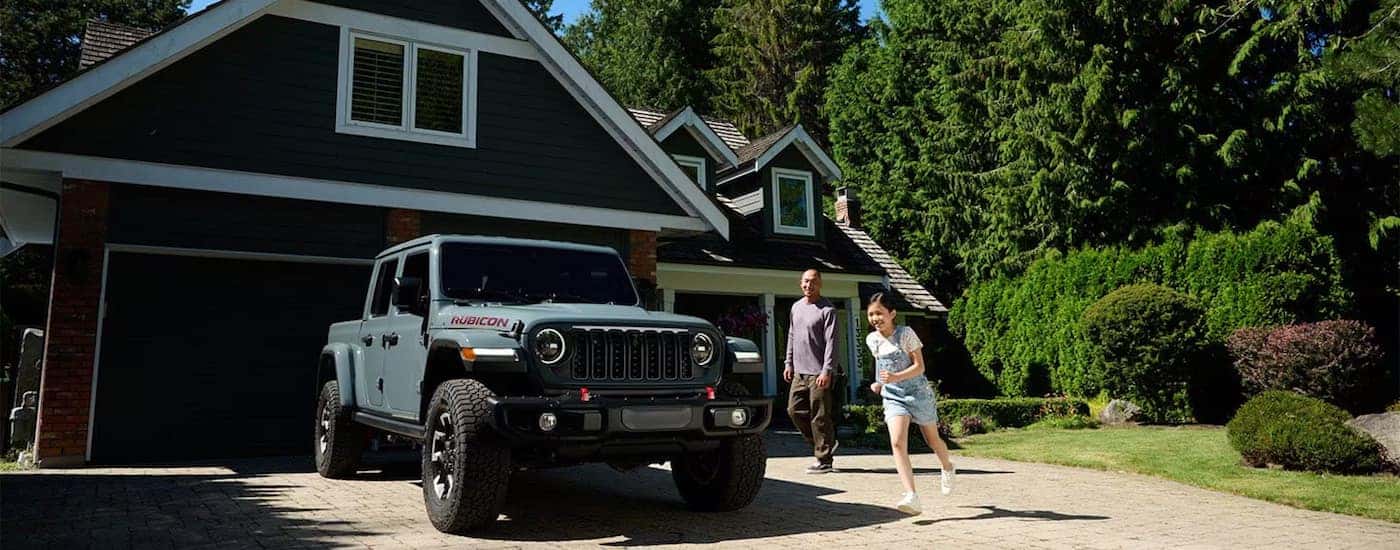 Grey 2024 Jeep Gladiator Rubicon X for sale near Charlotte parked on a driveway.