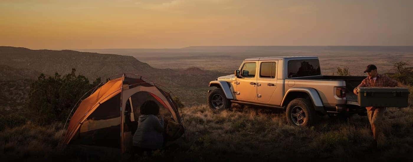 A silver 2024 Jeep Gladiator for sale near Concord at a campsite.