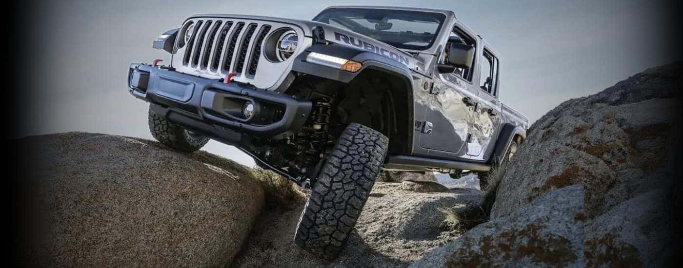 A silver 2023 Jeep Gladiator for sale near Davidson off-roading.