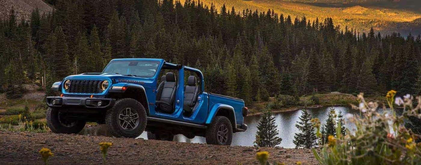 A blue 2025 Jeep Gladiator for sale near Denver from the front at an angle.