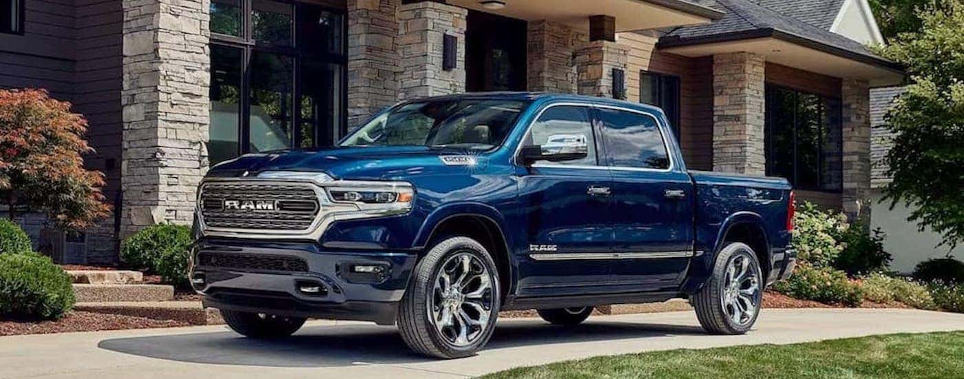 A blue 2023 Ram 1500 from the side.