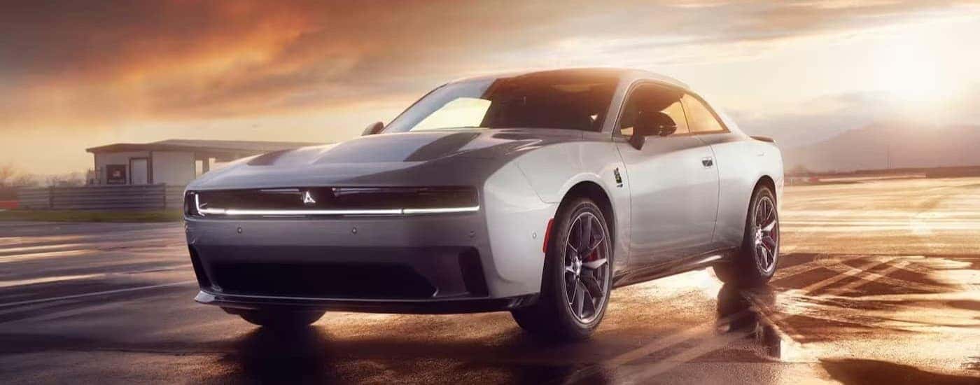 A white 2024 Dodge Charger Daytona parked on a track.