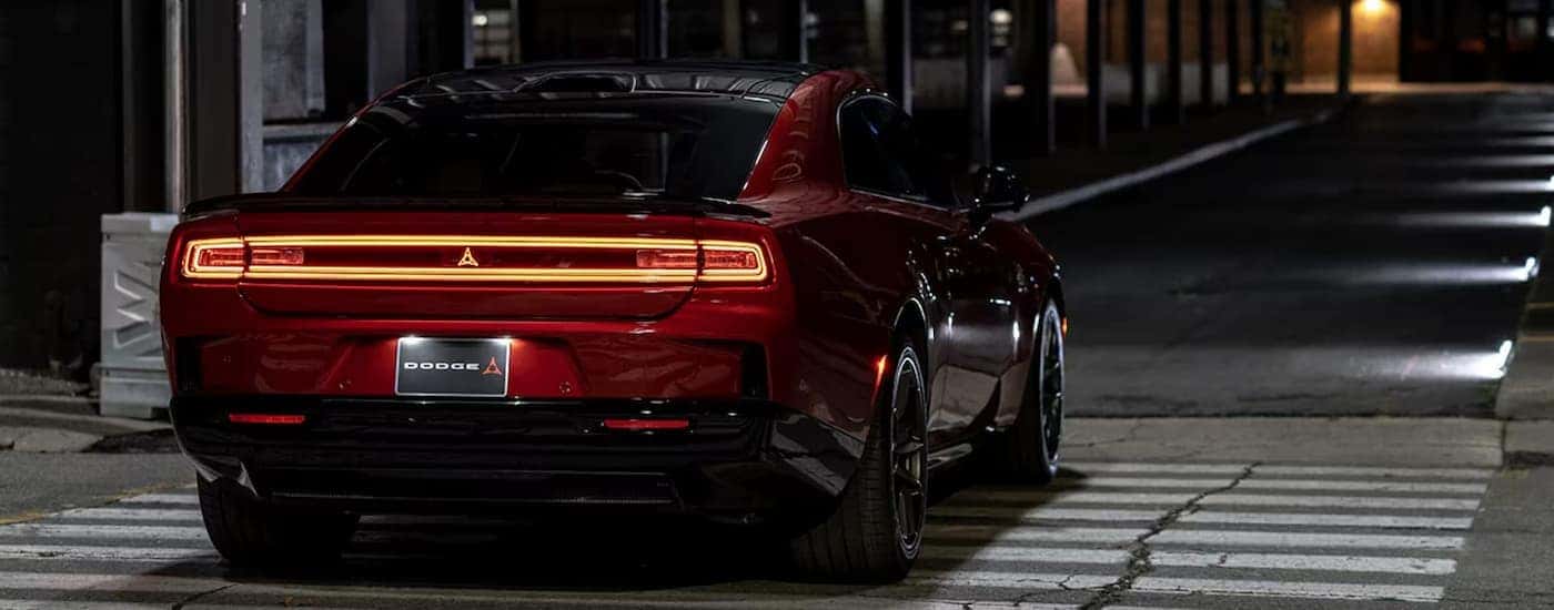 Taillights on a red 2025 Dodge Charger parked in a city at night