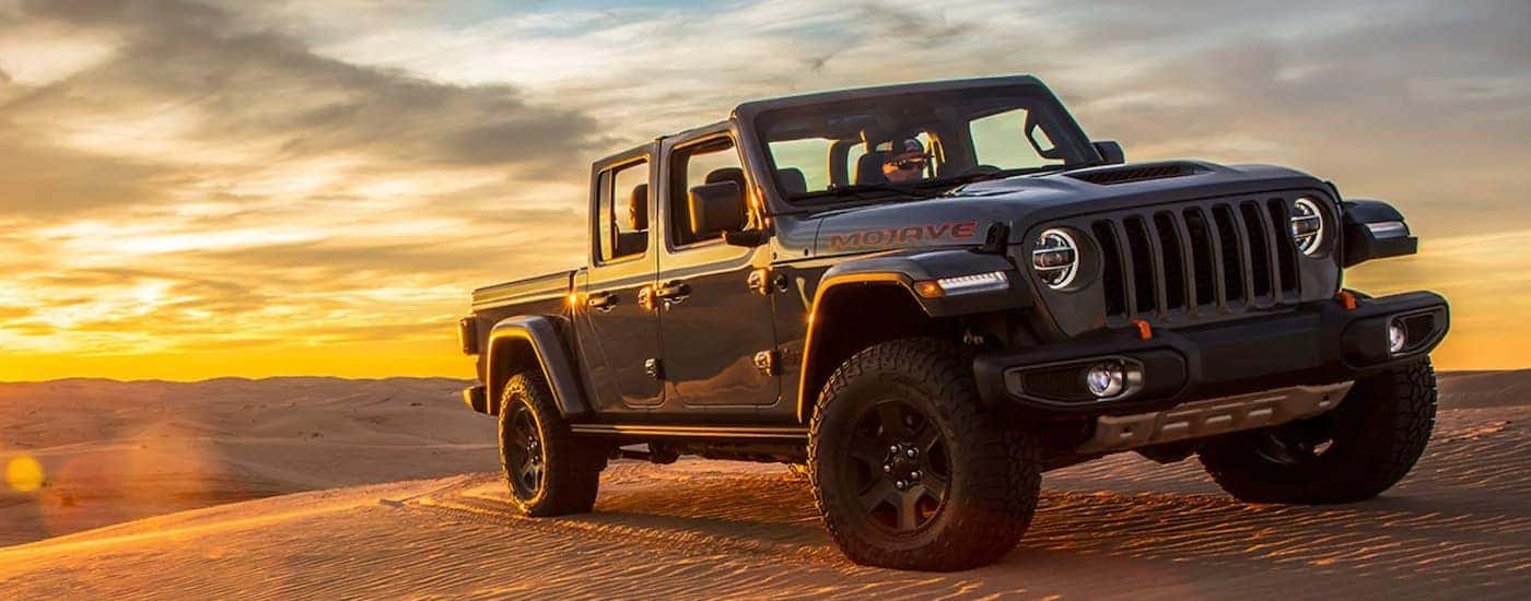 Black 2020 Jeep Gladiator driving on sand dunes