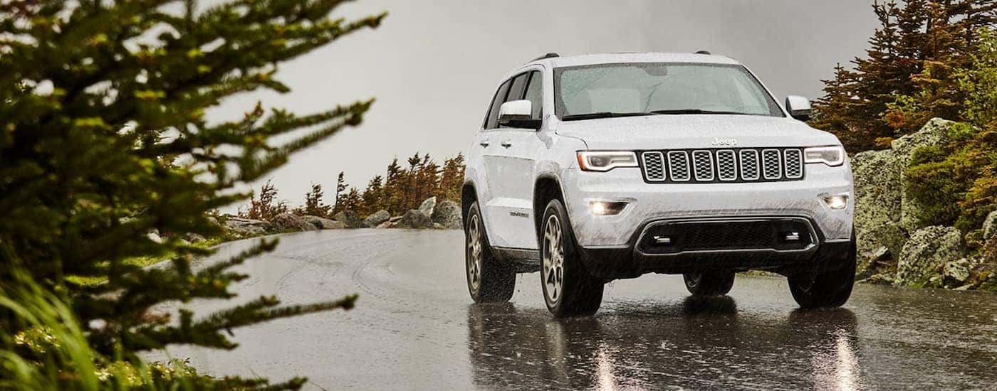 White 2021 Jeep Grand Cherokee driving to look at used Jeeps for sale in Cornelius