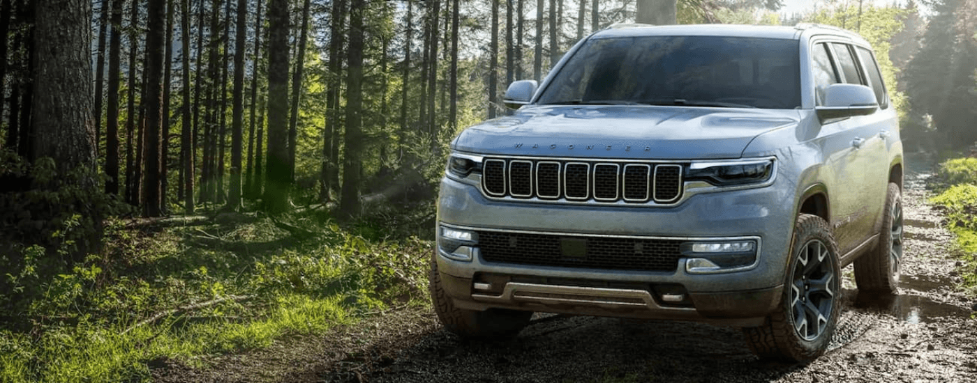 Silver 2022 Jeep Grand Wagoneer driving off-road