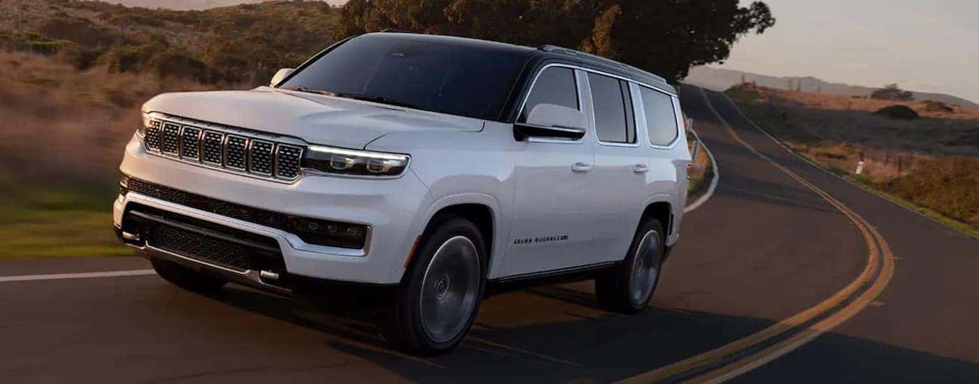 White 2022 Jeep Grand Wagoneer driving to look at used Jeeps near Huntsville