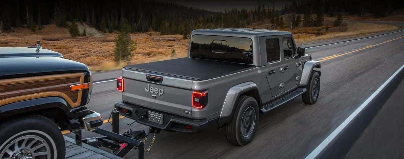 Silver 2022 Jeep Gladiator driving to look at used Jeeps for sale near Charlotte