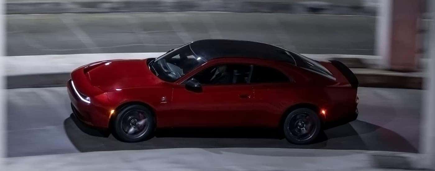 A red 2025 Dodge Charger for sale near Concord from the side.