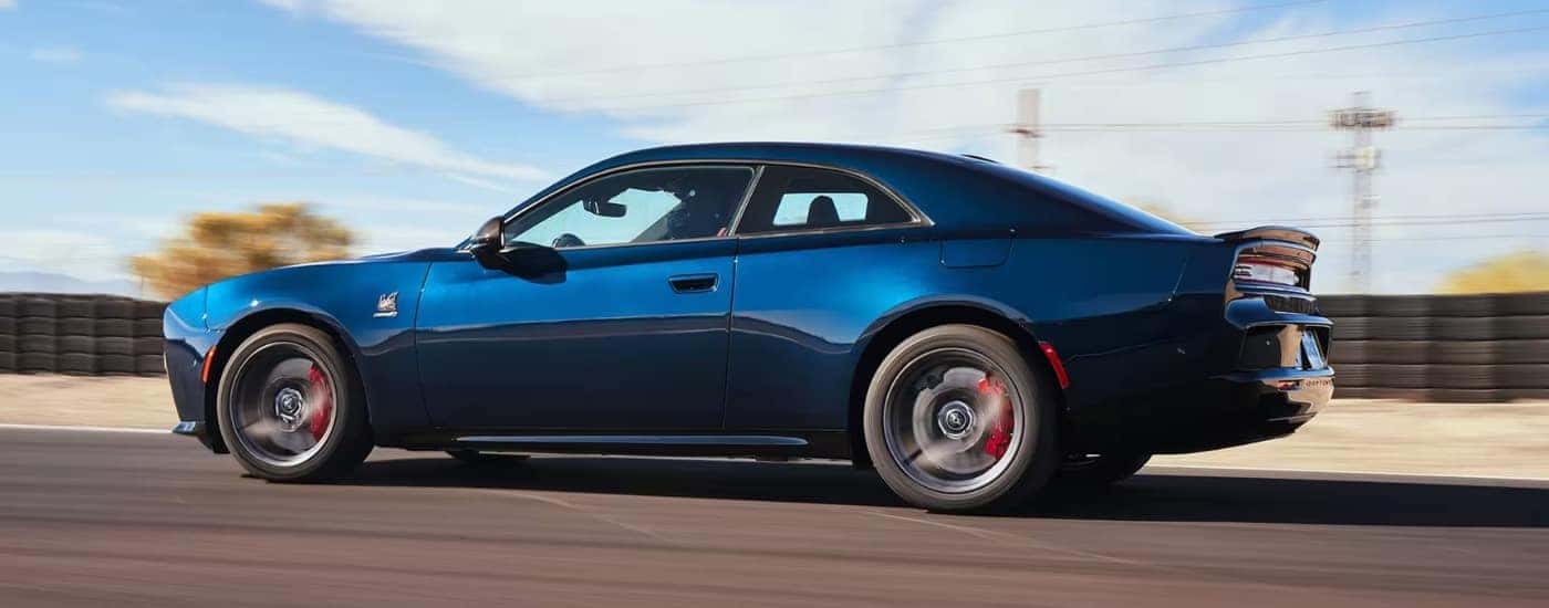 A blue 2025 Dodge Charger from the side.