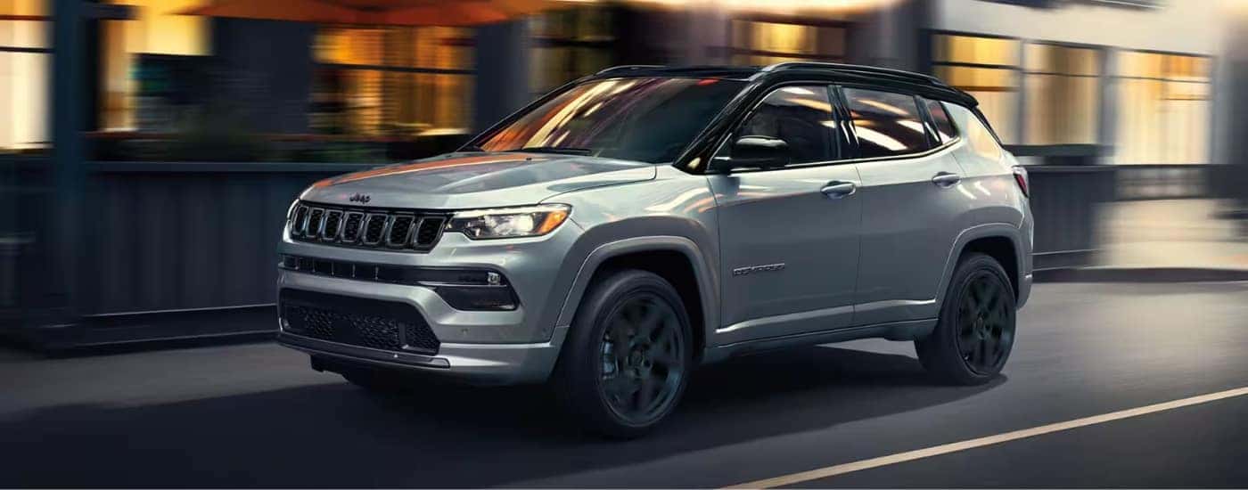 A silver 2024 Jeep Compass from the side.