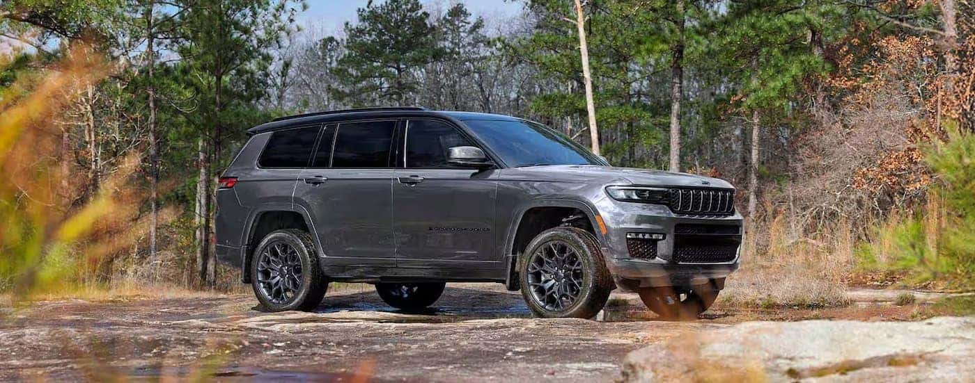 A silver Jeep Grand Cherokee parked offroad.