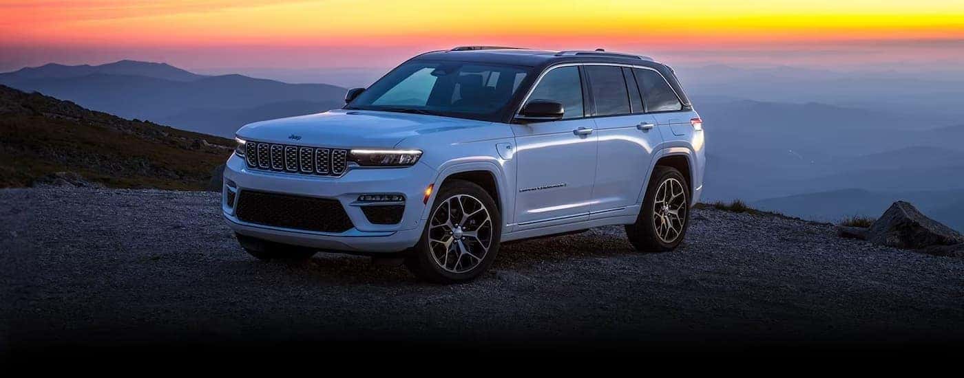 A white 2025 Jeep Grand Cherokee parked off-road.