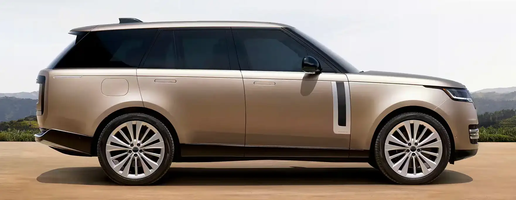 Land Rover technician walking toward a Range Rover ready for pick-up