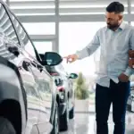 Car salesman talking to a couple about a new vehicle