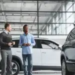 A couple looking at a new vehicle at a car dealership