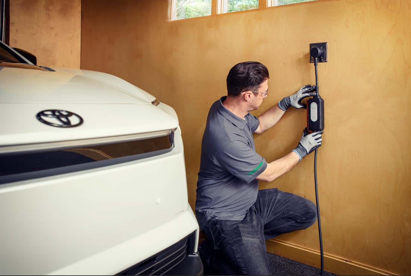 Treehouse technician installing Level 2 home EV charger for Lexus electric vehicle charging