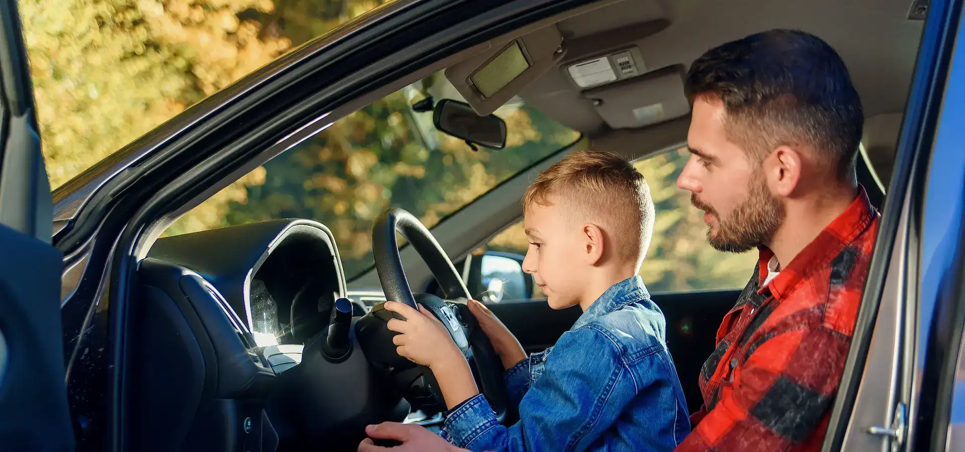Father teaching his son about the car