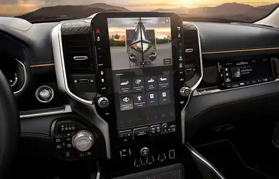 14.5-inch Uconnect touchscreen on the 2027 Ram 1500 dashboard at sunset