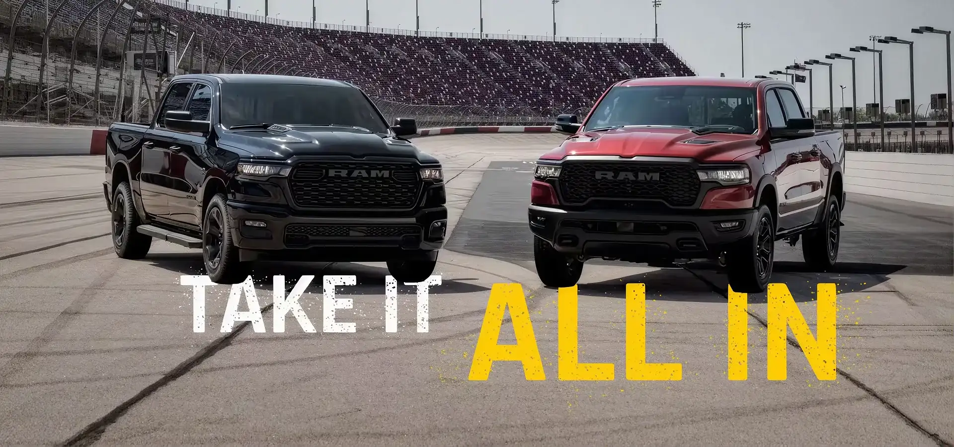 Take it all in - black and red 2027 Ram 1500 pickups facing each other at a racetrack