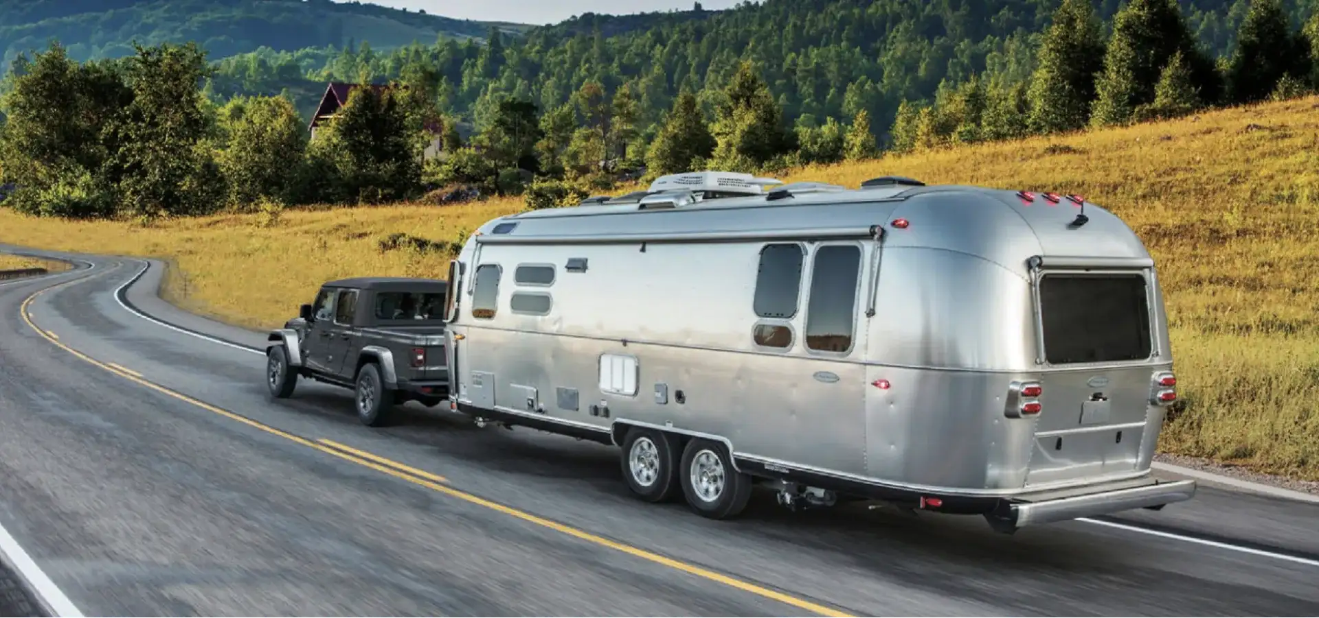 Jeep Gladiator towing a silver Airstream travel trailer