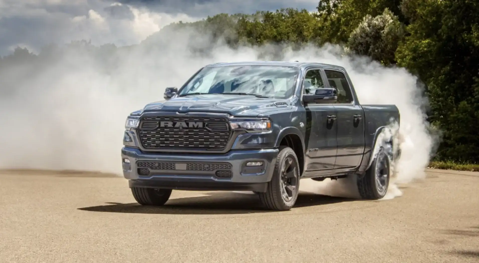 2026 Ram 1500 in dark gray doing a burnout on a paved road