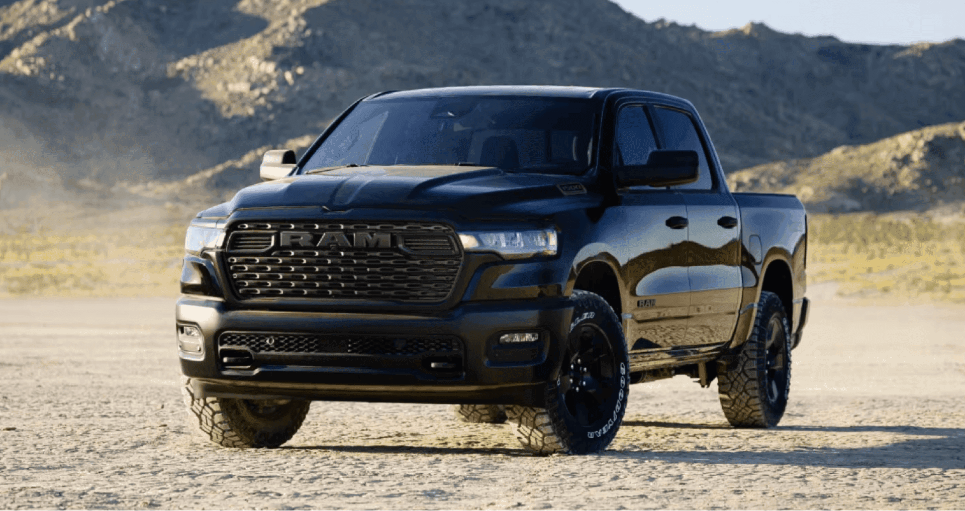 Ram 1500 crew cab parked on a desert road near mountains, available with Ram lease deals at Sierra CDJR of Monrovia