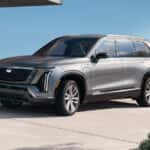 2026 Cadillac Vistiq exterior in silver parked near a residential building