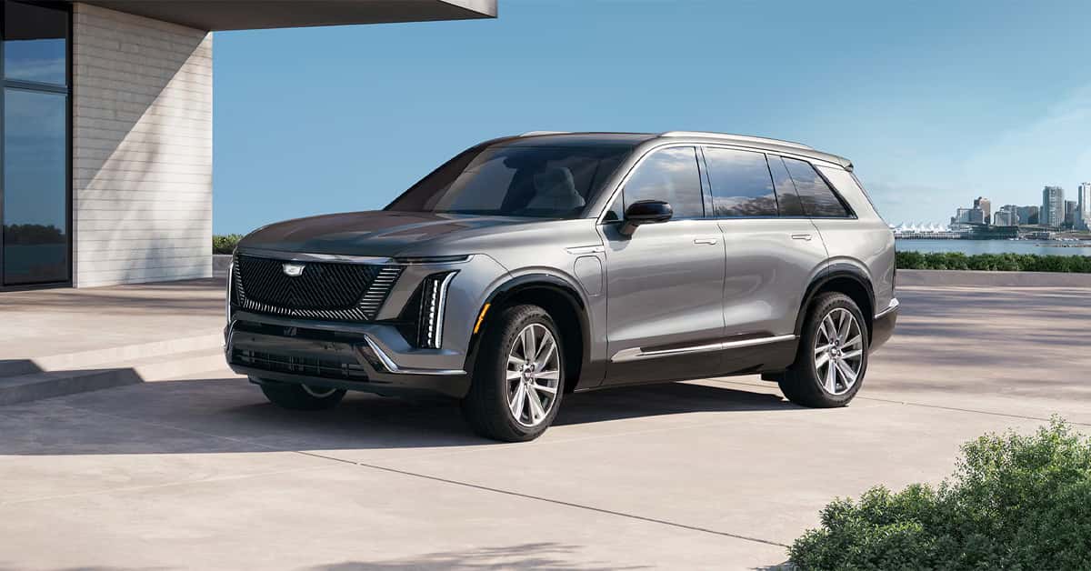 2026 Cadillac Vistiq exterior in silver parked near a residential building