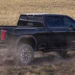 2026 GMC Sierra HD driving through a field