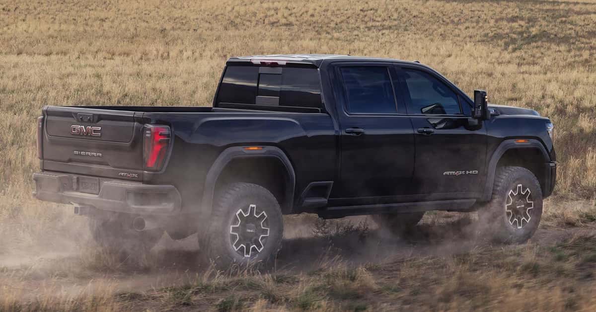 2026 GMC Sierra HD driving through a field