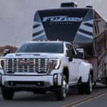 GMC Sierra HD towing a large Keystone Fuzion fifth-wheel toy hauler/RV