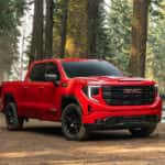 2026 GMC Sierra 1500 parked on a dirt clearing in a dense forest