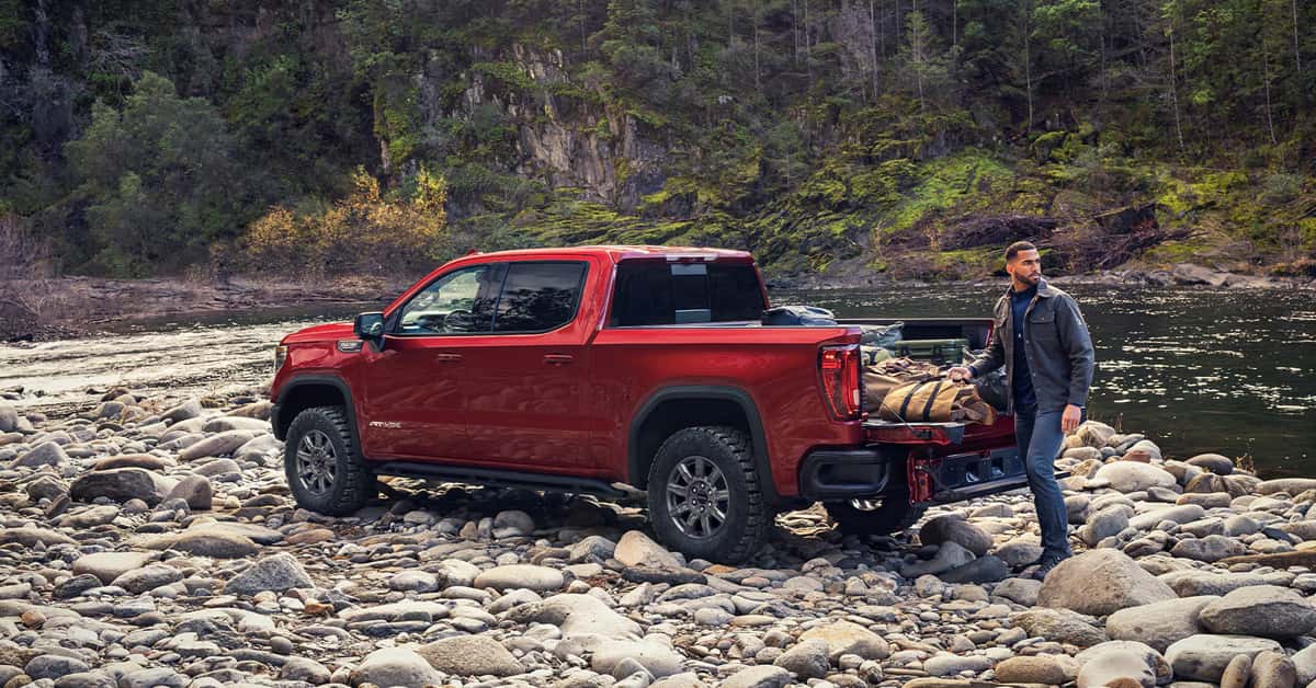parked on a rocky riverbank with its MultiPro Tailgate lowered