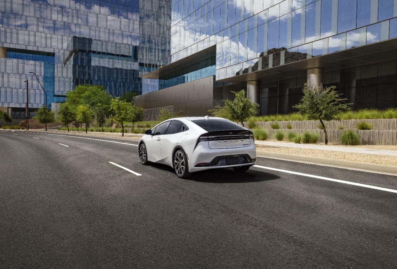 Driver charging a Toyota Prius Prime near Cornell University