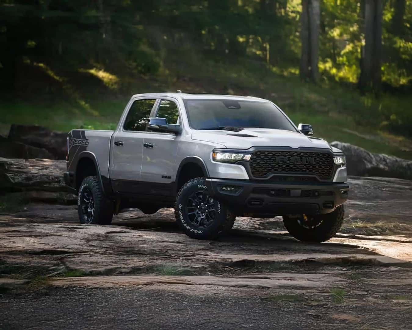 Front 3/4 shot of the 2026 RAM 1500 parked in the mud.