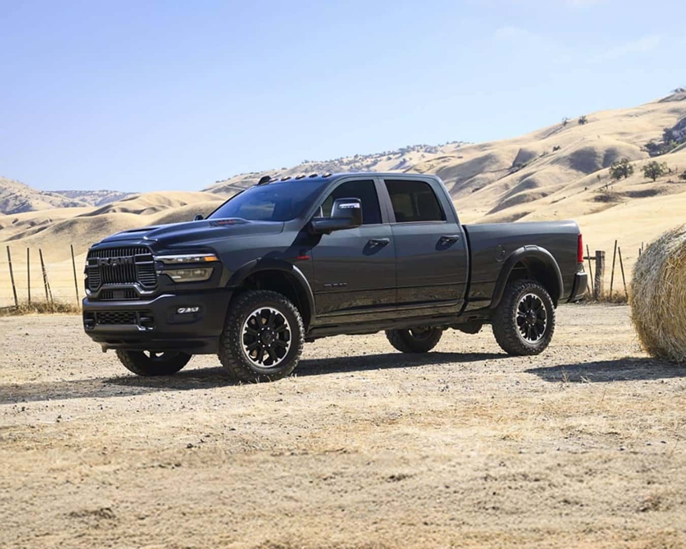 Side profile shot of the 2026 RAM 2500 parked on farm land