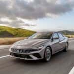 Gray Hyundai Elantra sedan driving on a highway