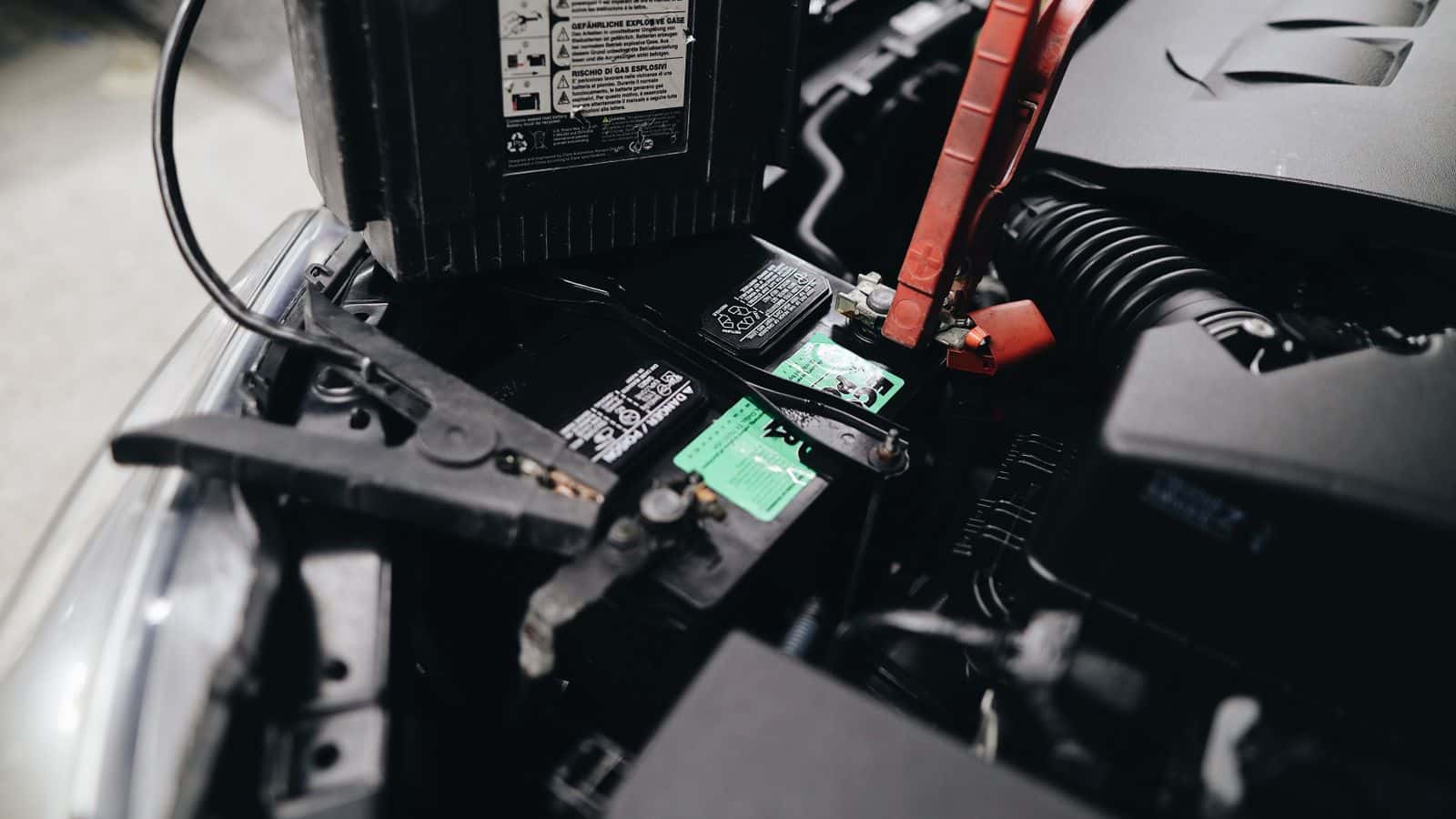 Car battery in an engine bay during a battery replacement at Mariano Rivera Honda