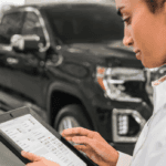 woman looking at tablet in service garage