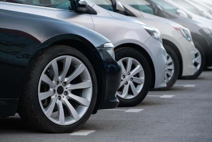 A lot of cars in a rows. Used car sales.
