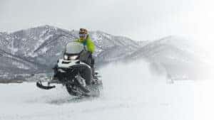 The Snowmobile in high jump above track.