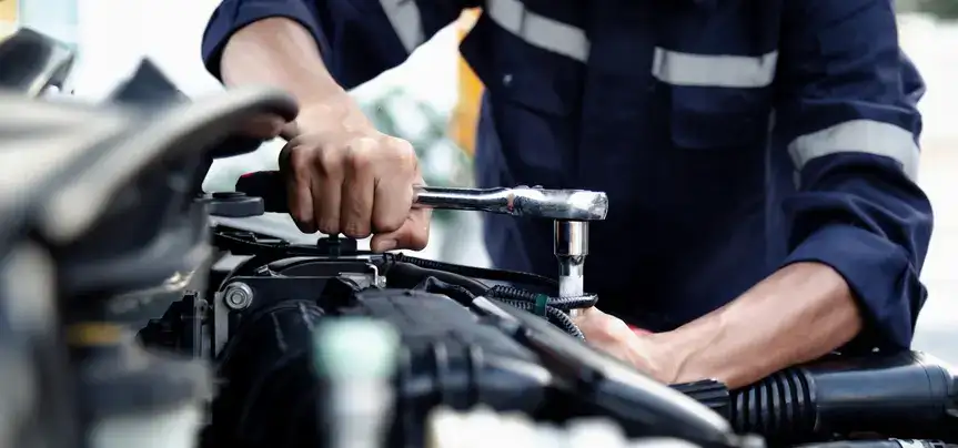 auto mechanic working on engine