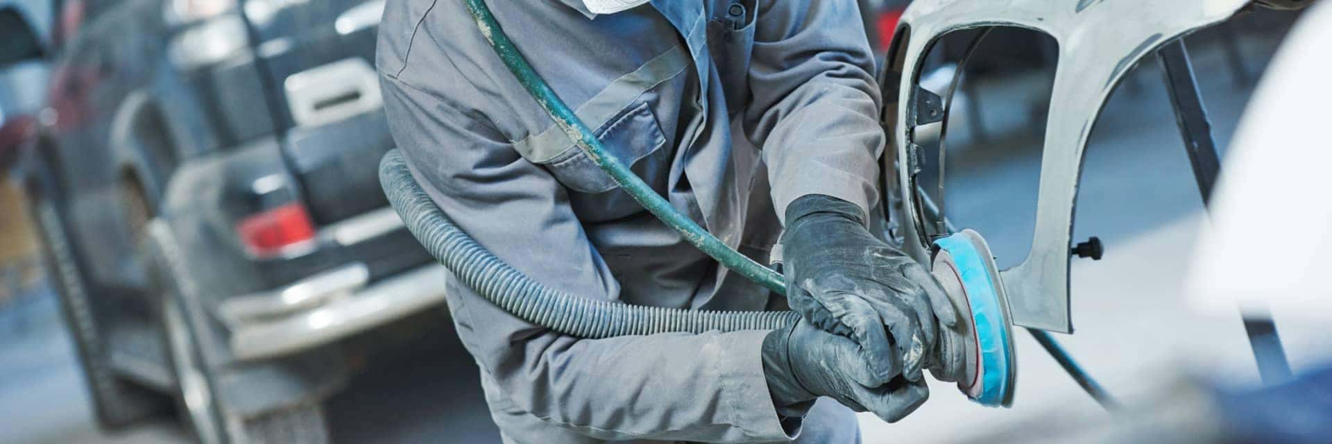 collision technician working on vehicle
