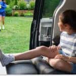 Rear captain's chair with an extended leg rest inside the 2026 Toyota Sienna with the sliding door open.