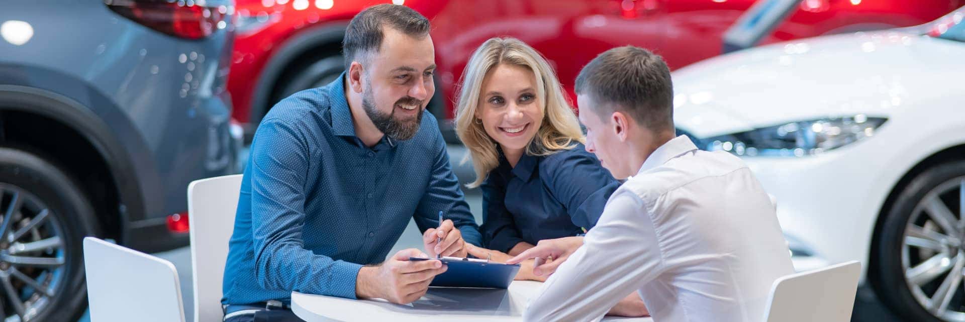 couple signing paper work with finance specialist